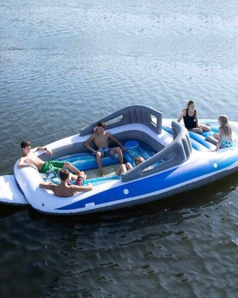 A boat on a body of water.  Life-size Inflatable Speed Boat