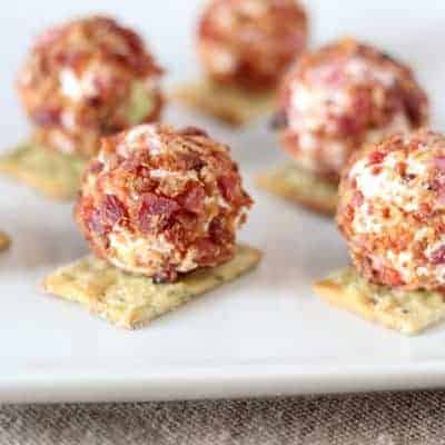 close up of cheeseball bites on white plate
