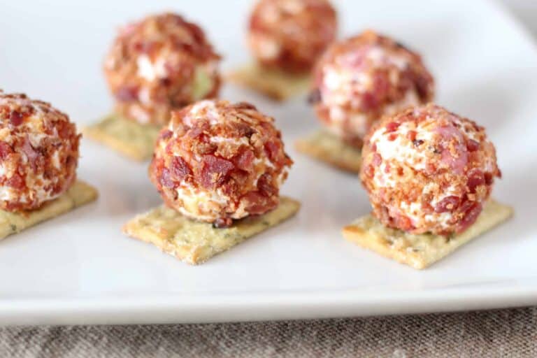 close up of cheeseball bites on white plate
