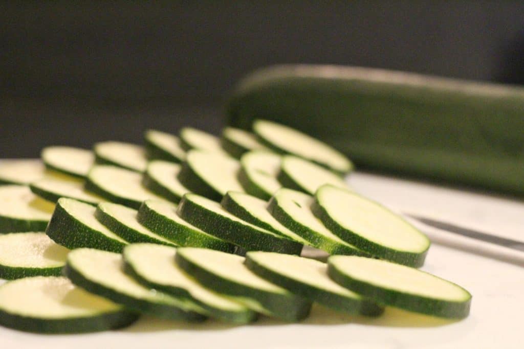 slicing zucchini chips to cook 