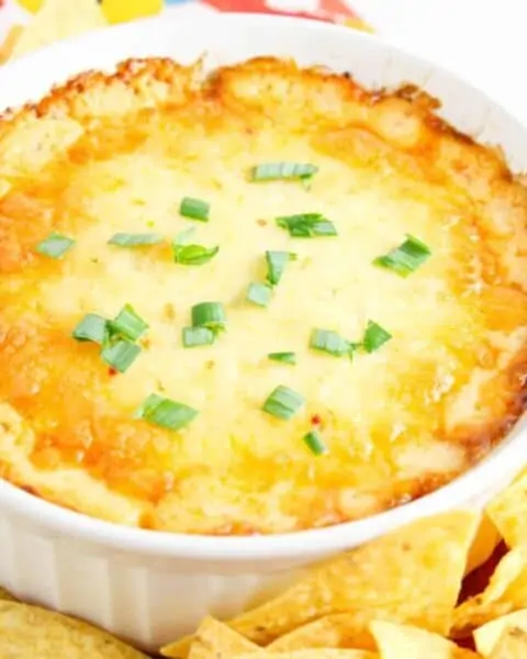 Baked chicken ranch dip with green onions and chips.
