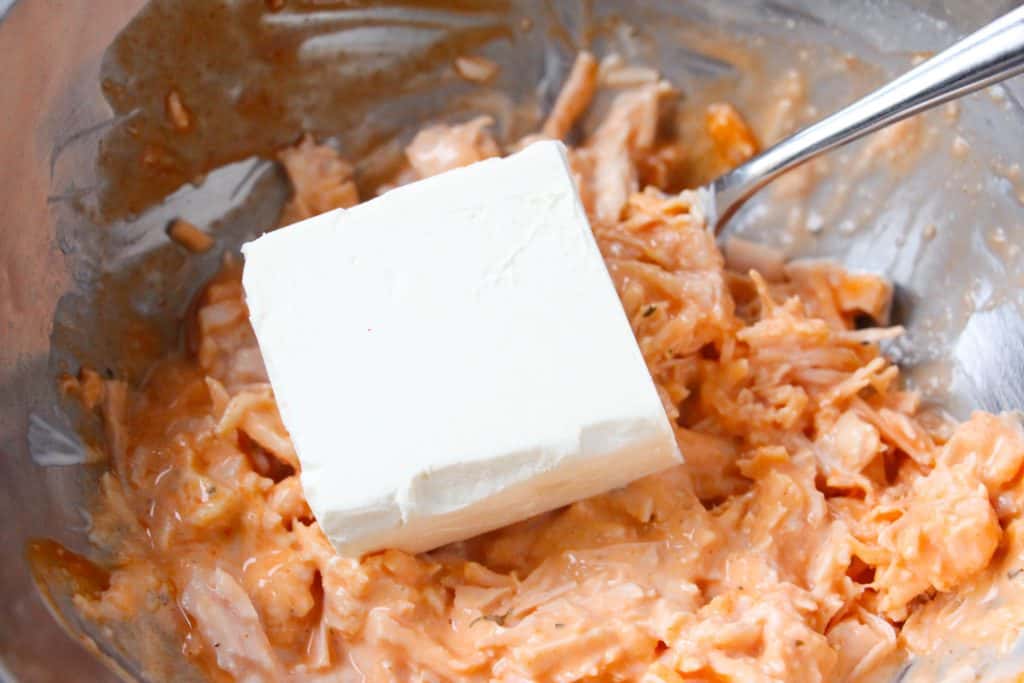 adding in the cream cheese to make the Cheesy Chicken Ranch Dip Recipe
