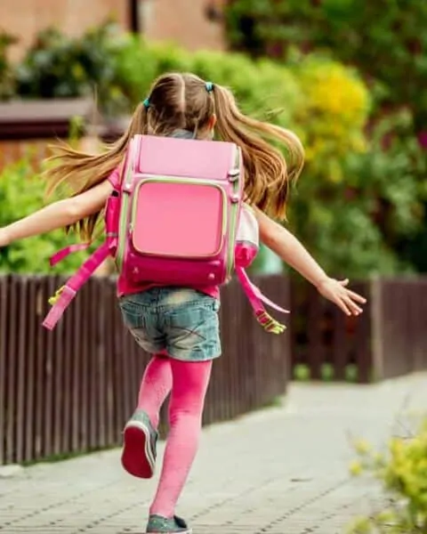 Little girl with pink backpack. | Back to school tips for saving money.