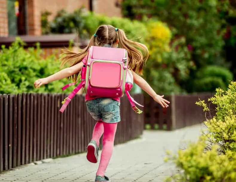 Little girl with pink backpack. | Back to school tips for saving money.