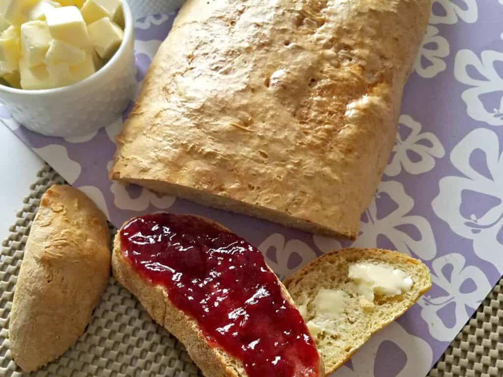Homemade French Bread Recipe with butter and jam.