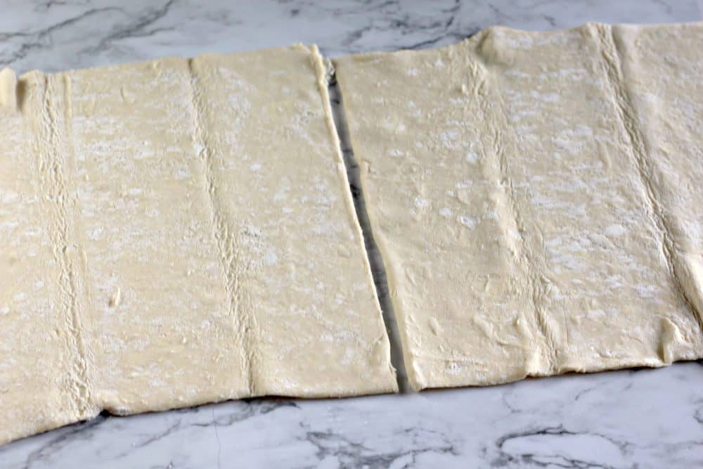 Puff pastry sheets on a flat surface.