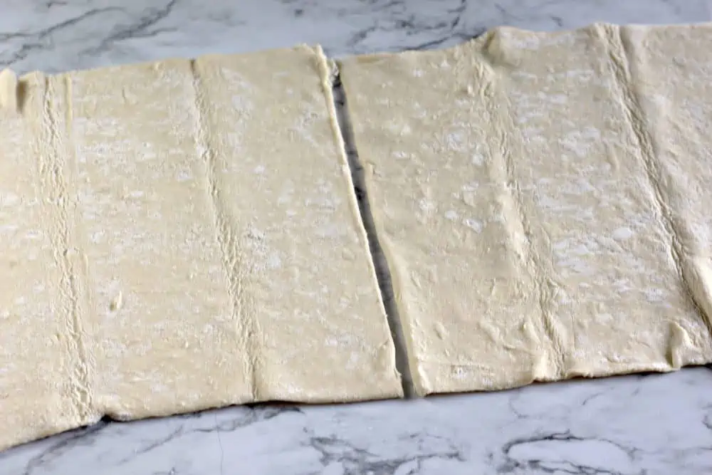 Puff pastry sheets on a flat surface.
