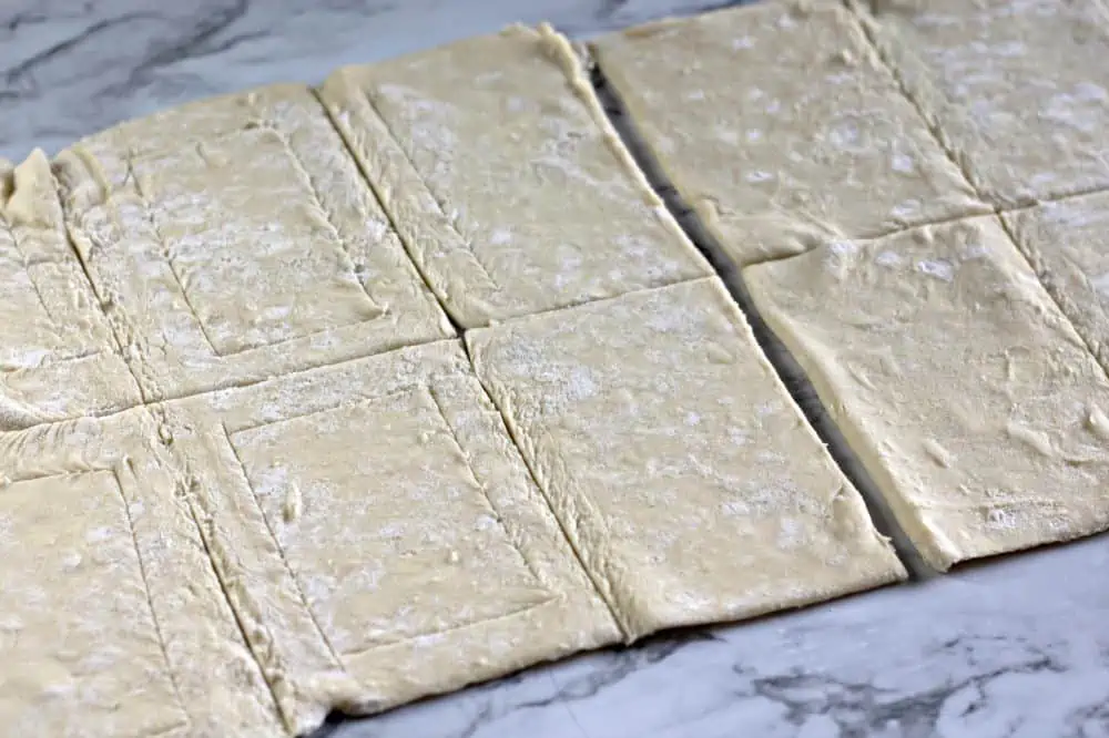Puff pastry rectangles on a cookie sheet.