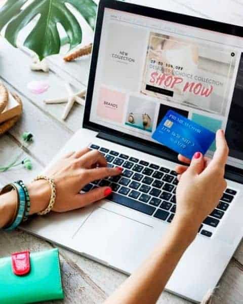 woman shopping online with her credit card out