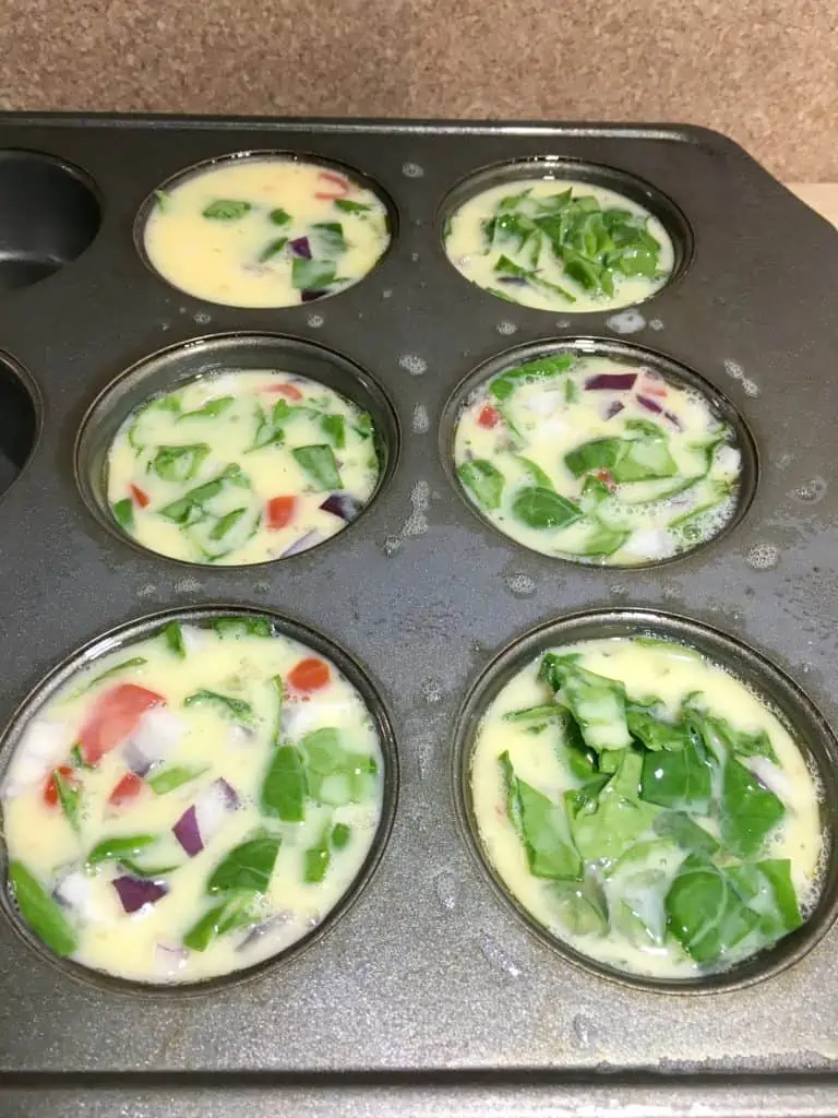 The egg muffin mixture in muffin tins.