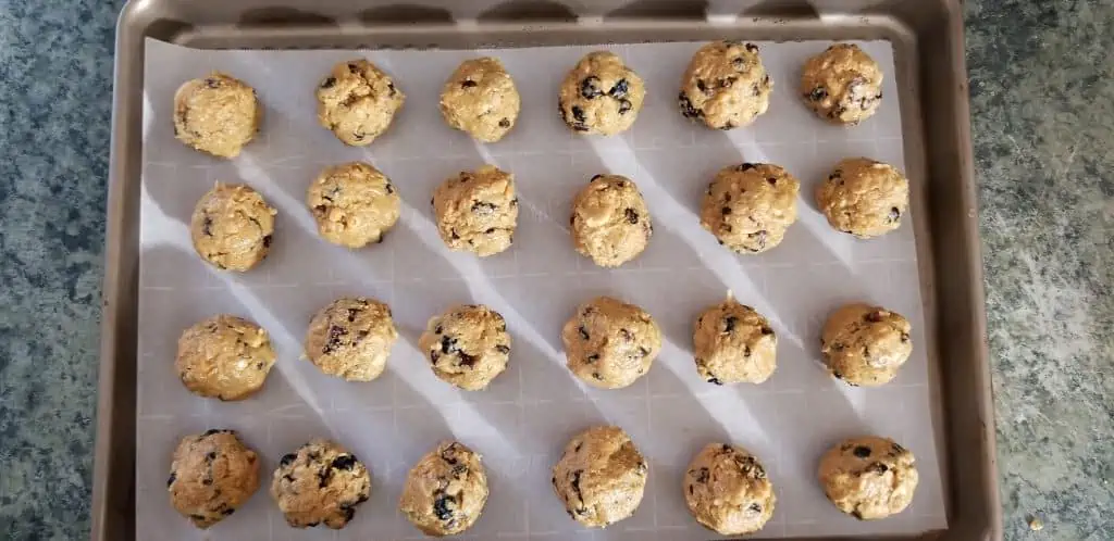 cookie sheet with rows of energy balls on it