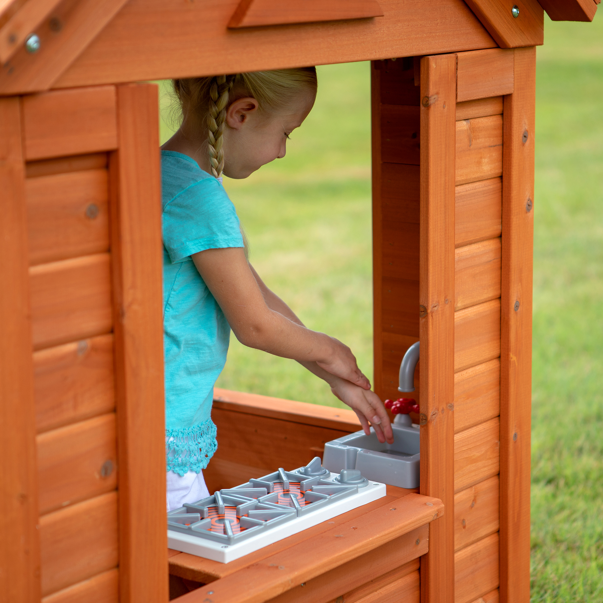 Little girl playing inside her Timberlake Cedar Wooden playhouse.