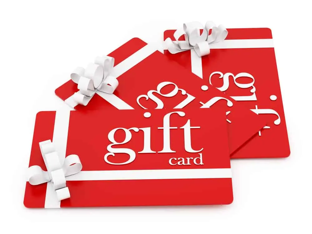 A stack of red gift cards with beautiful white ribbons.