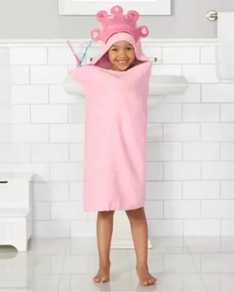 child wearing a princess hooded towel
