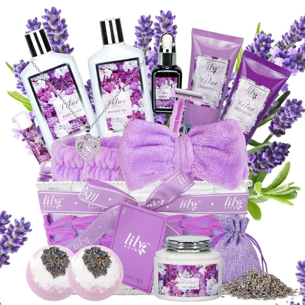 Gift basket with lilac bath products, a purple headband, bath bombs, and fresh lilac flowers.