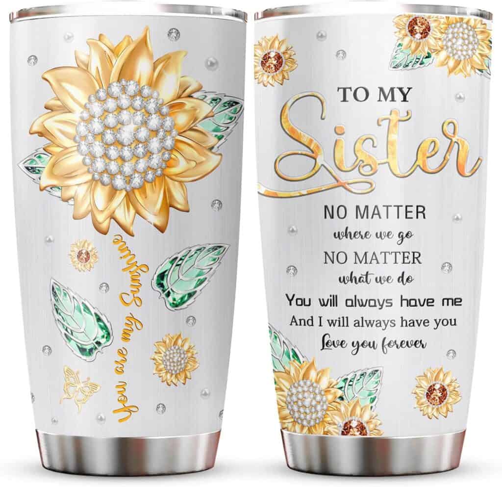 Two stainless steel tumblers with sunflower and jewel patterns, each featuring a heartfelt sister message in gold and black text.