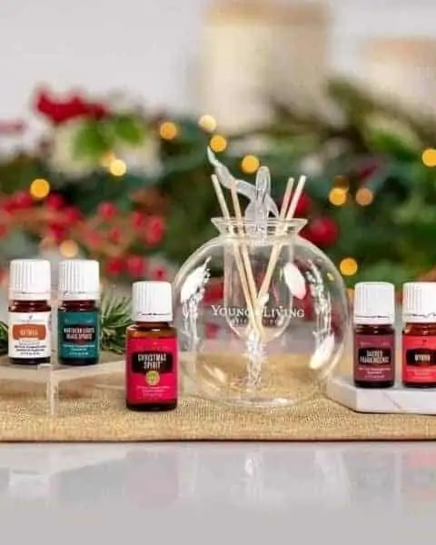 young living essential oil bottles in front of a Christmas background