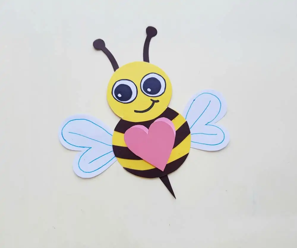 adding the heart to the paper bee craft