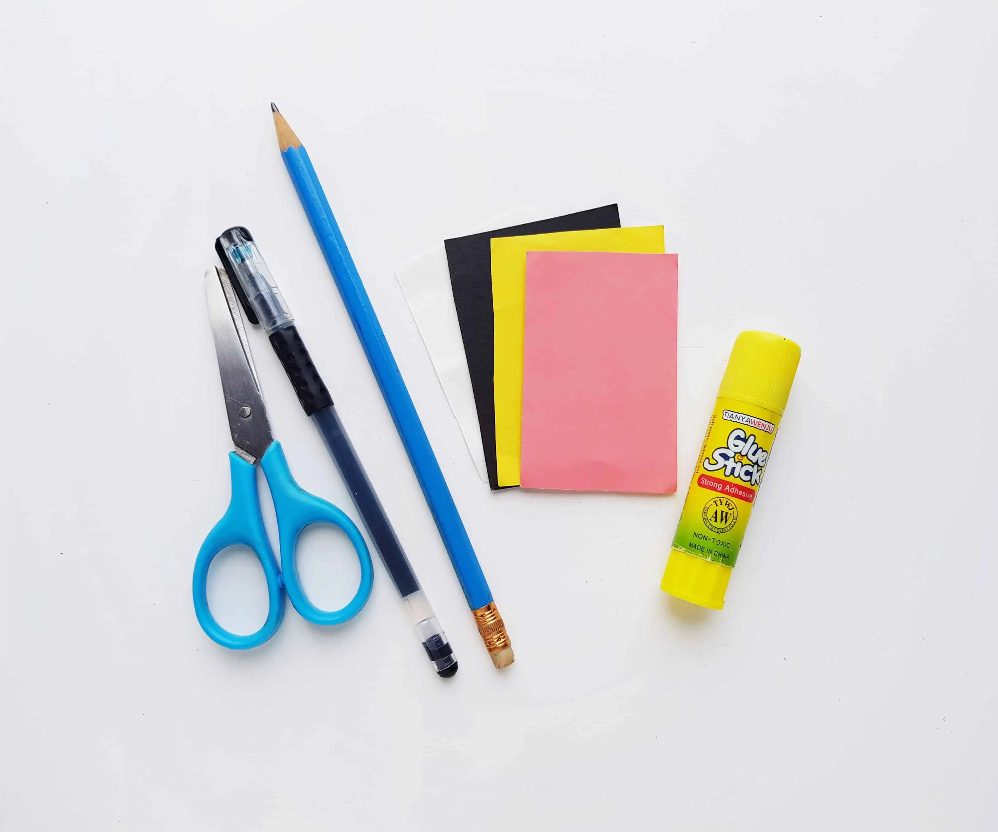 craft supplies, paper, scissors, glue stick, gel pen, pencil