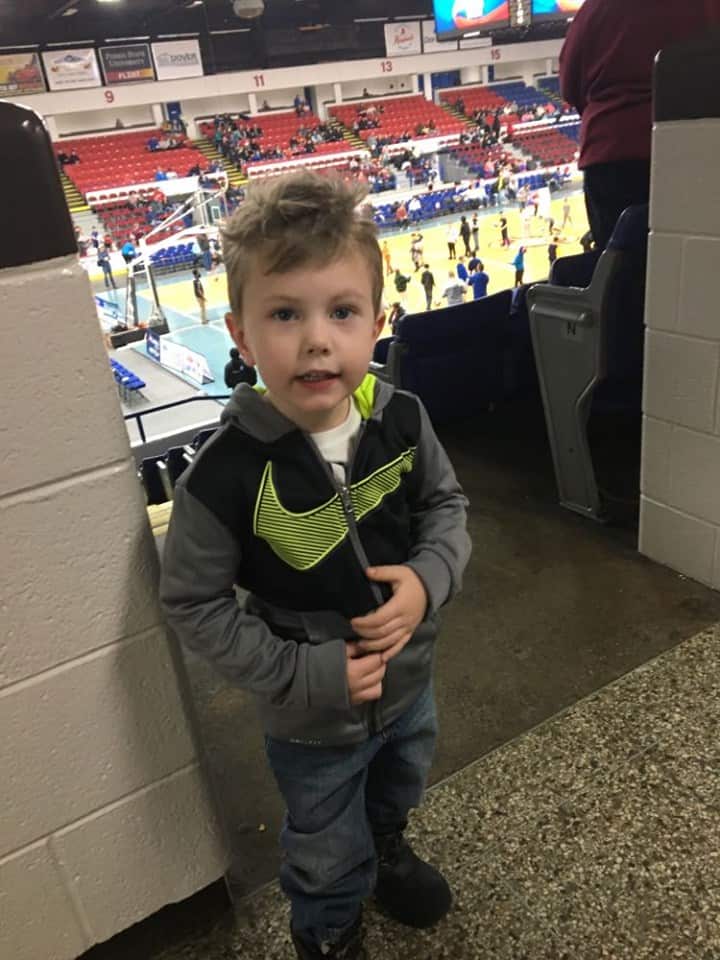 A little boy watching the Harlem Globetrotters.