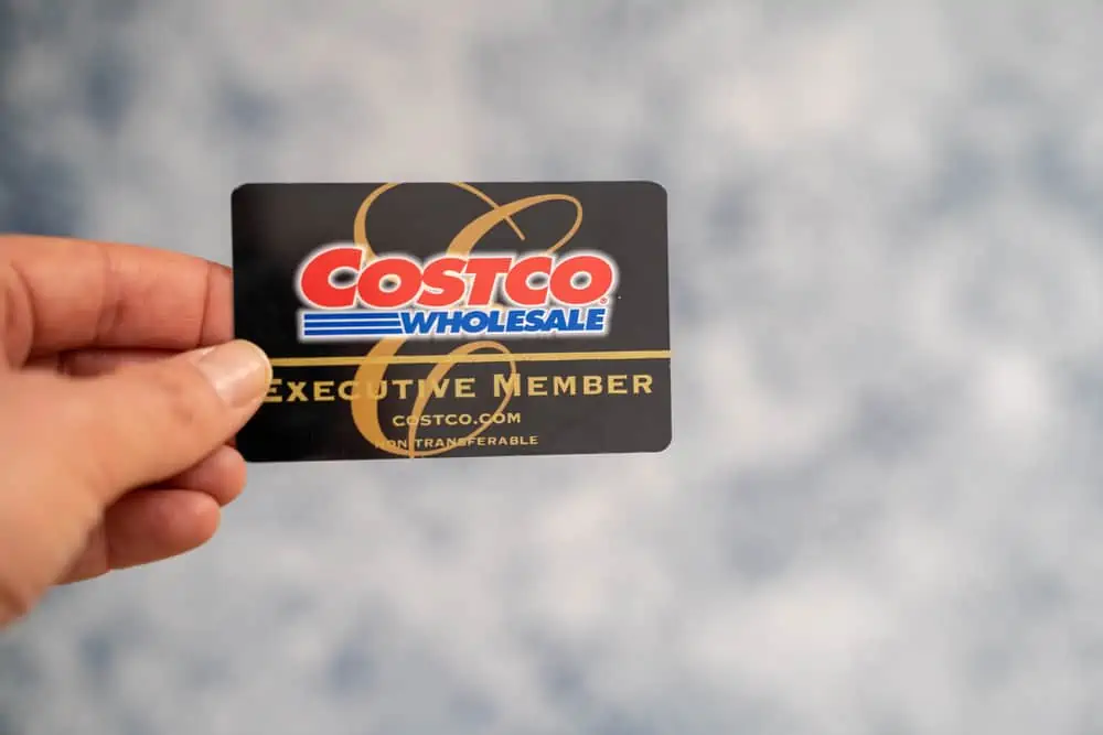 Hand holding a Costco Wholesale Executive Membership card.