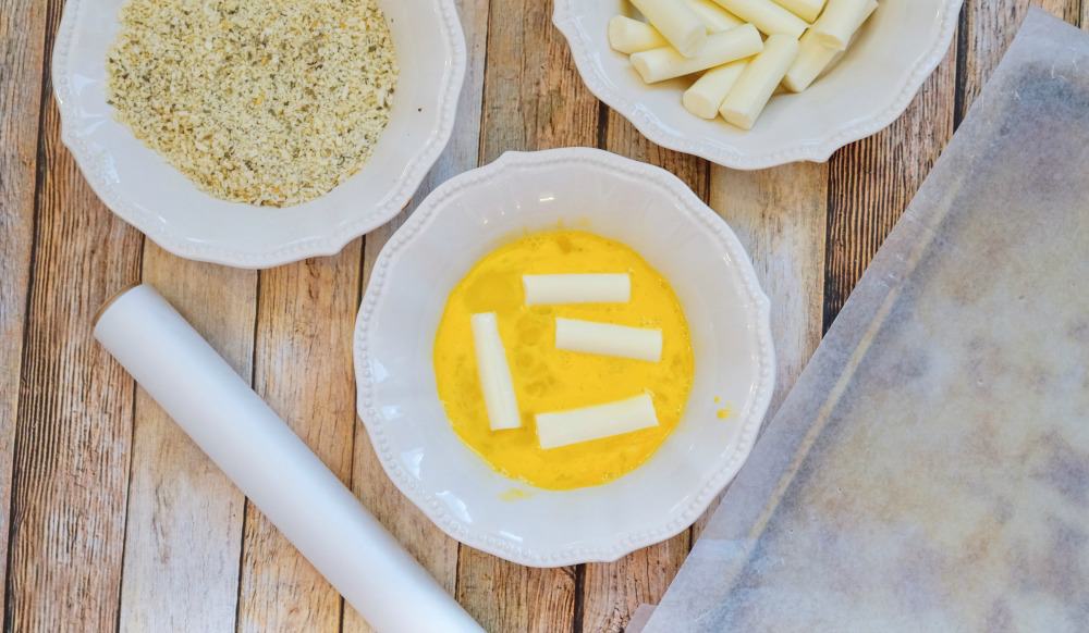 A plate of food on a wooden table, with Mozzarella and Egg