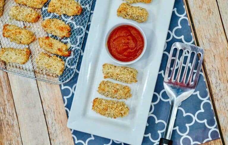 mozzarella cheese sticks on a plate with marinara sauce