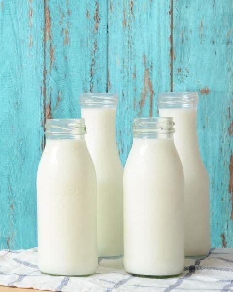 four bottles of white milk