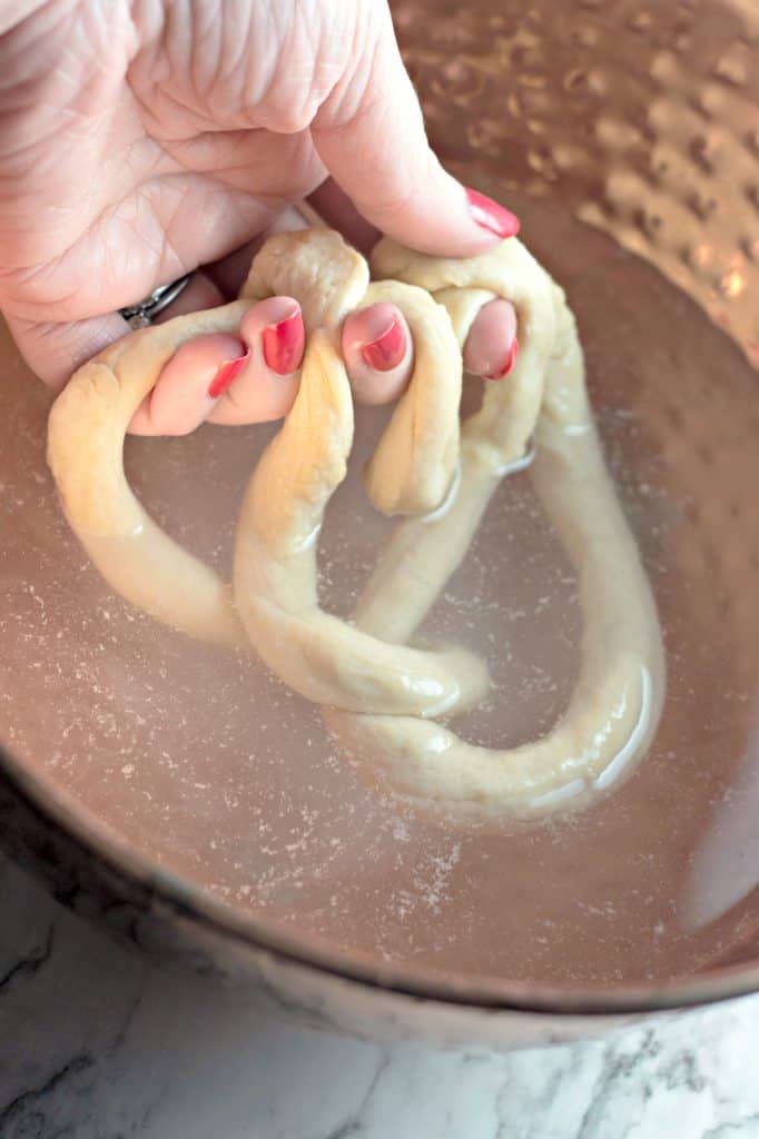 Dip pretzel dough into a baking soda mixture.