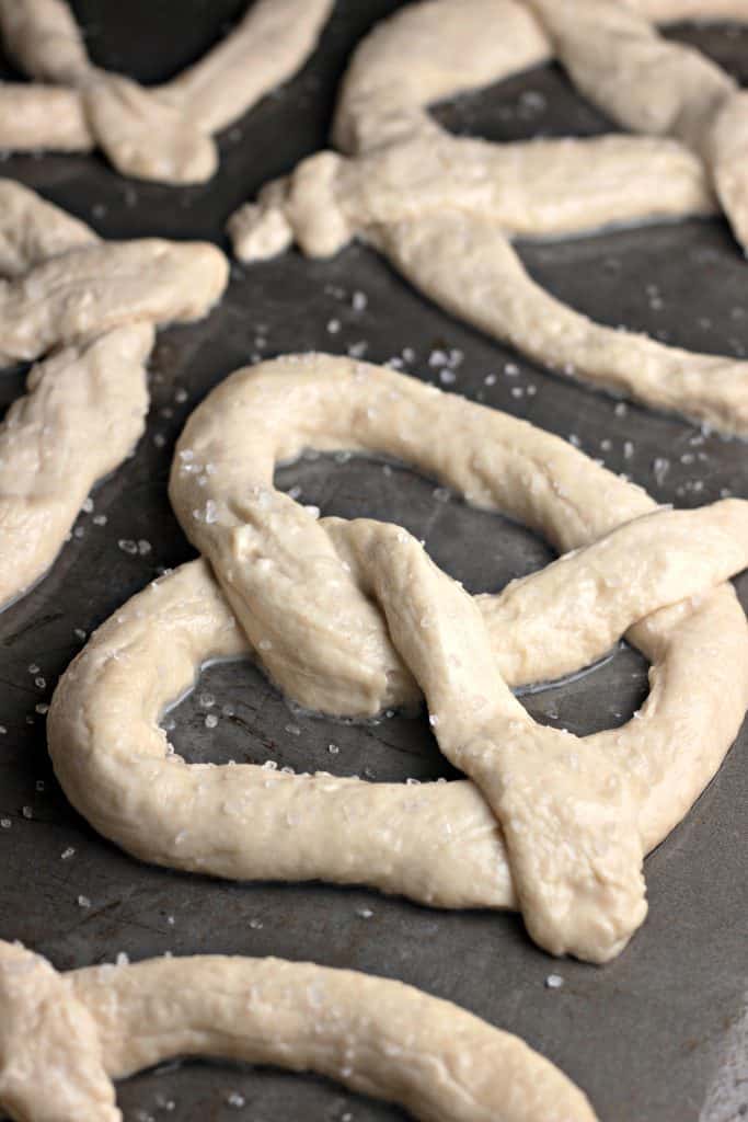 Scatter salt on pretzel dough.