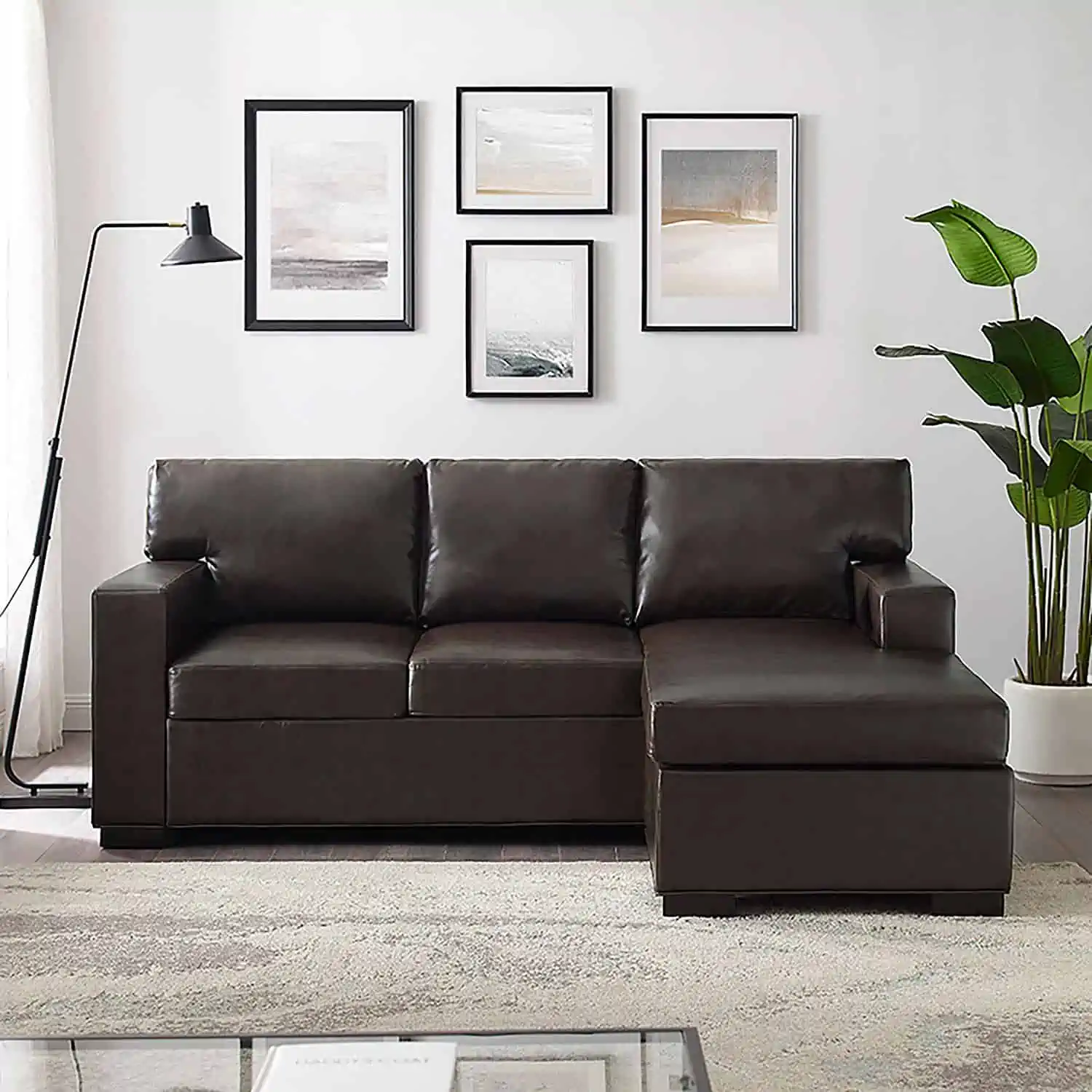 A brown leather sectional couch in a living room from Sam\'s Club.