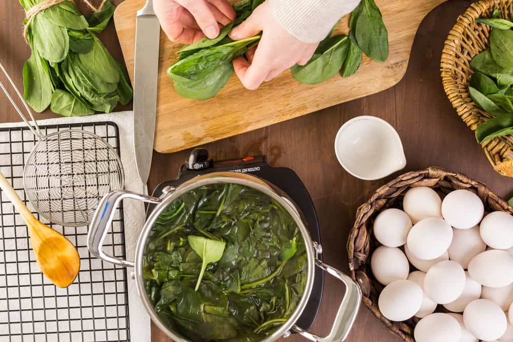 Dyeing Easter eggs with natural dye from spinach.