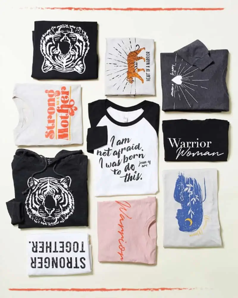 Close ups of a variety of t-shirts from the Warrior Women clothing line collection.