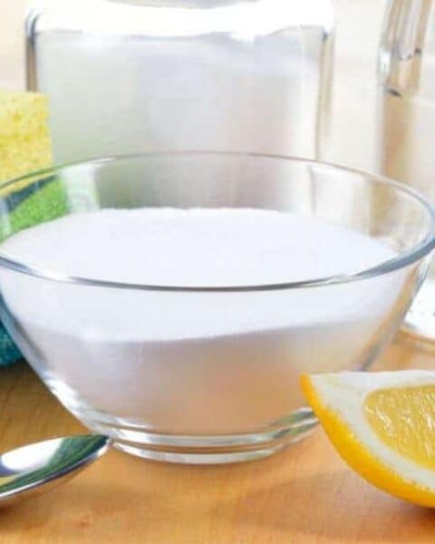 Supplies you need for homemade cleaners, including lemon, sponge, towels, and other simple ingredients.