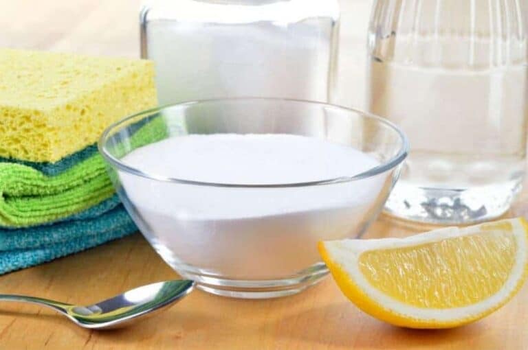 Supplies you need for homemade cleaners, including lemon, sponge, towels, and other simple ingredients.