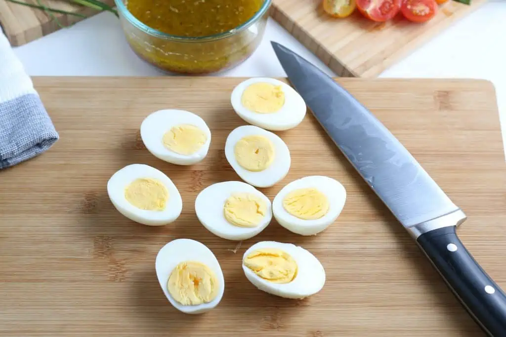 Cut hard boiled eggs for Cobb salad.