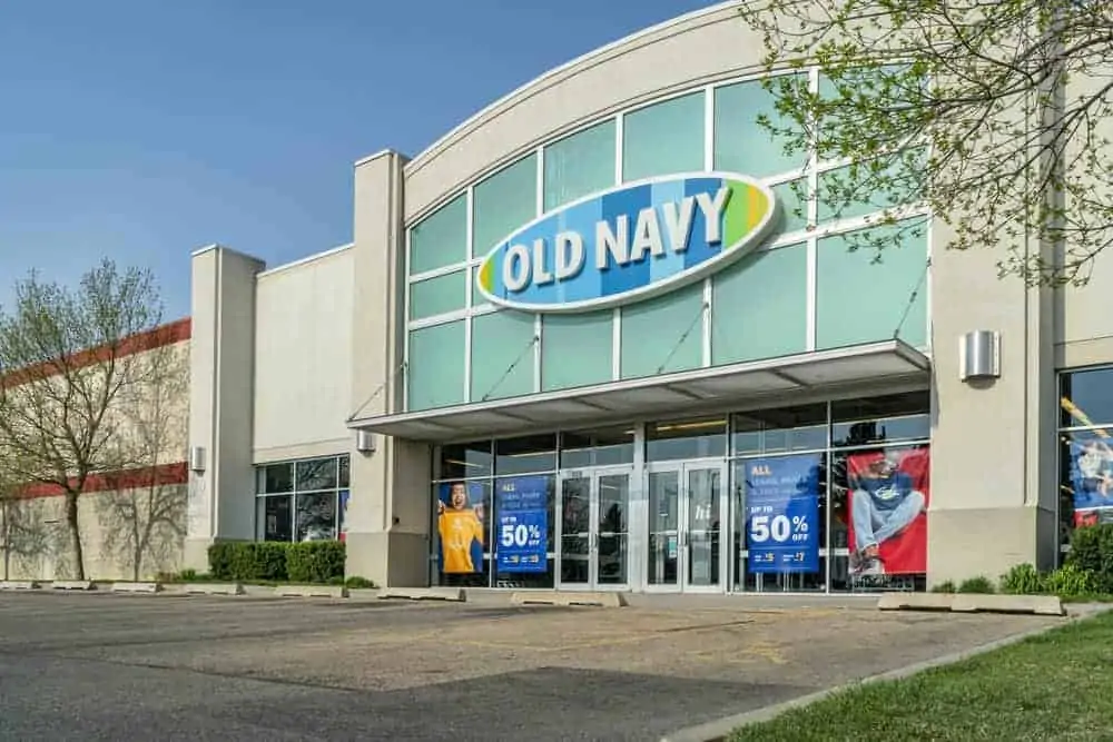 Old Navy storefront with signs on the windows.