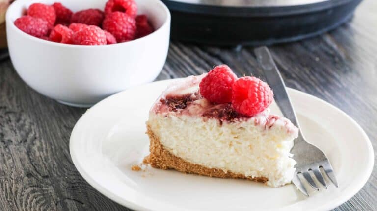 A slice of raspberry cheesecake recipe made from an instant pot.