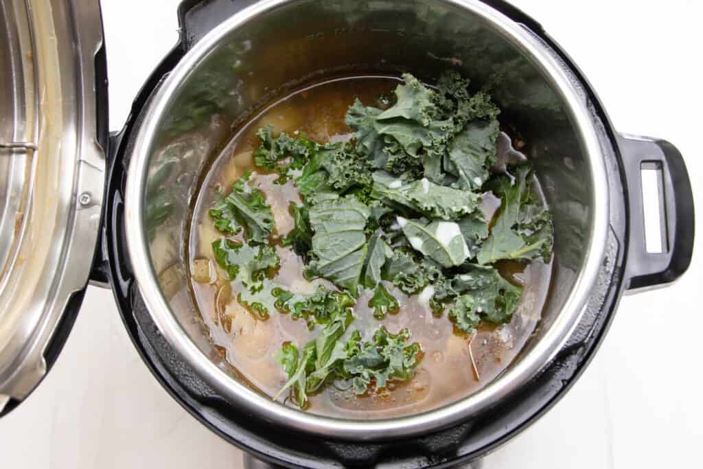 Stir in the kale for the Zuppa Toscana from Olive Garden