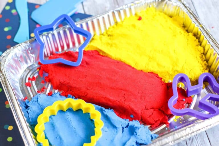 Kinetic sand with plastic cookie cutters.