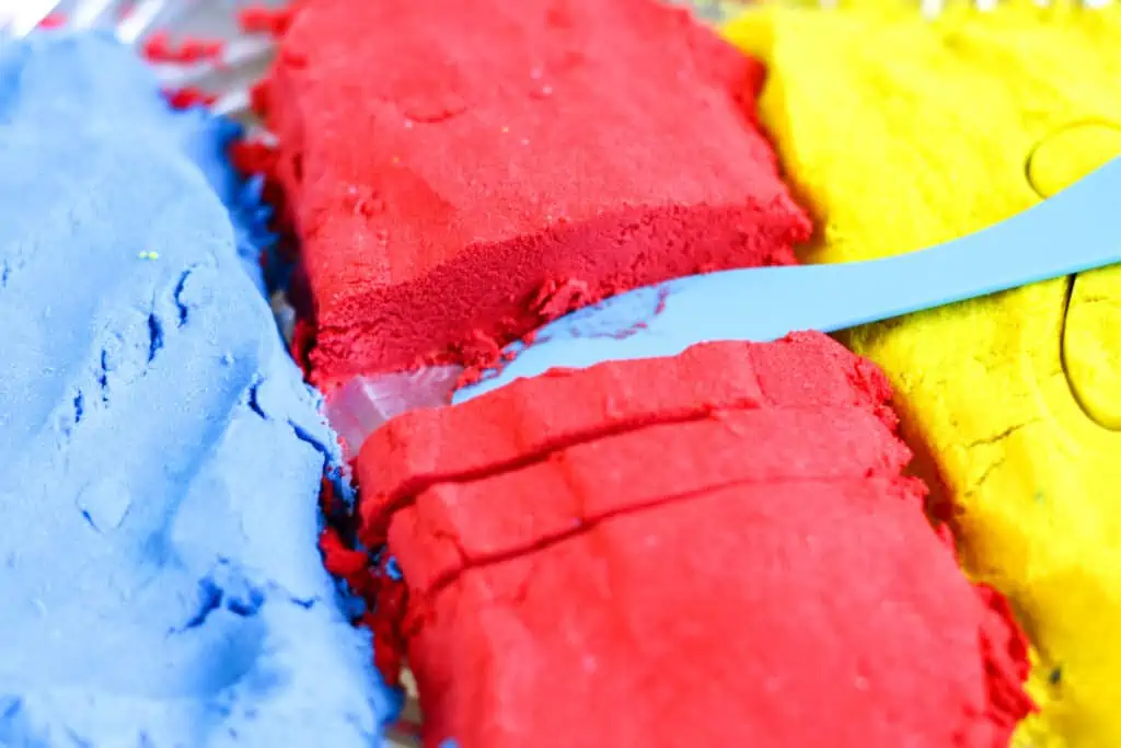 Blue, red, and yellow Homemade Kinetic Sand Recipe