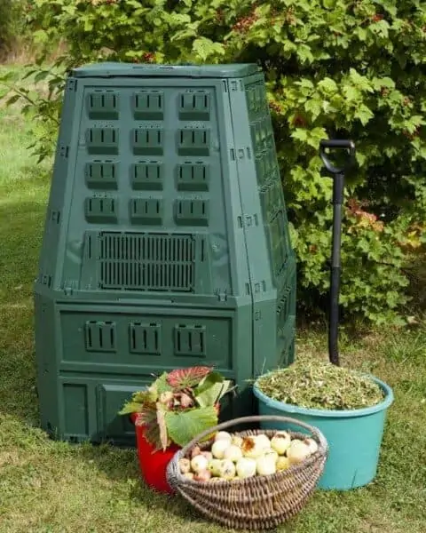 compost bin with buckets of food scraps sitting nearby