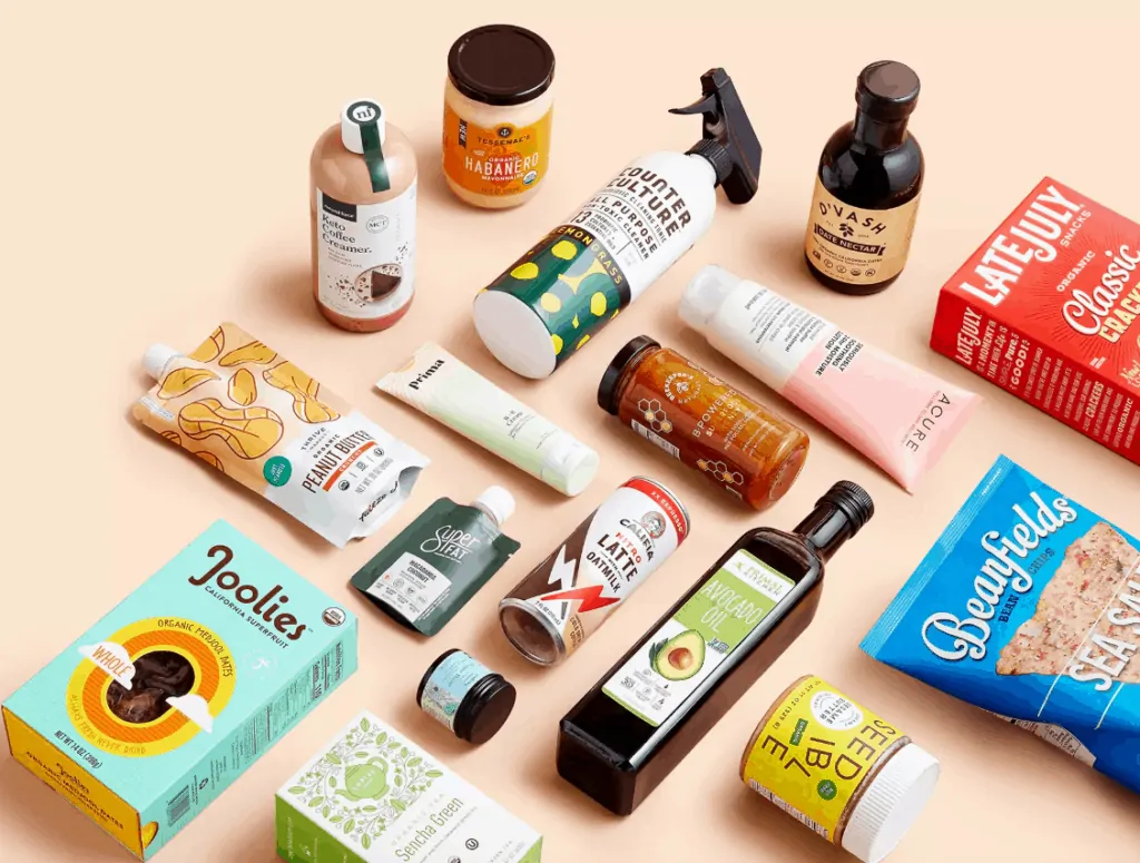 Several natural food, cleaning and health and beauty products laying on a table. 