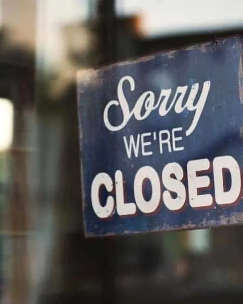 sign hanging in a door saying sorry we're closed