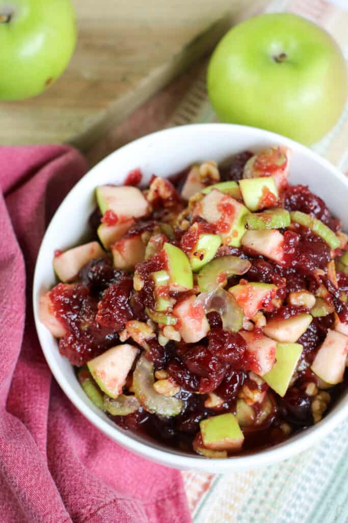 a bowl filled with homemade cranberry apple walnut salad.