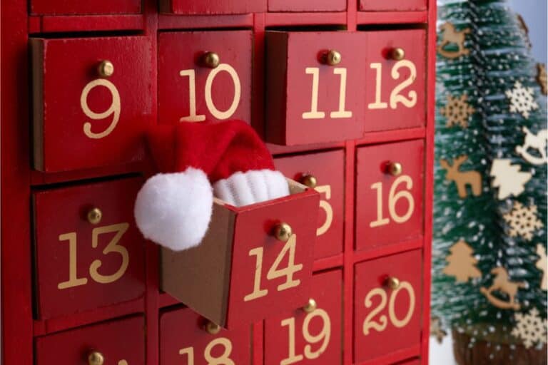 Christmas advent calendar with a little Santa hat coming out of box 14.