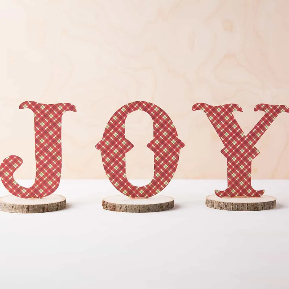 JOY sign on wood with red decorative plaid.