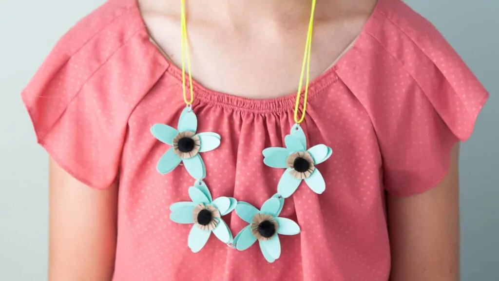 Flower heart around little girl's neck.