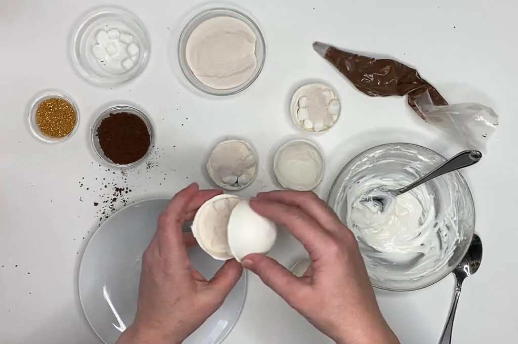 Place chocolate powder inside chocolate cup to make white chocolate cocoa balls.