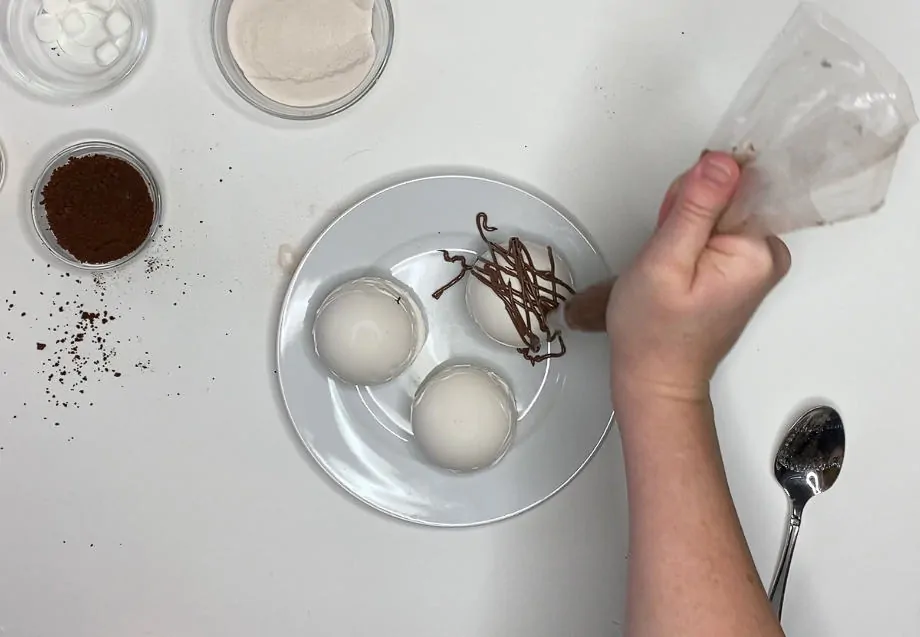 Add chocolate to top of white chocolate cocoa balls.